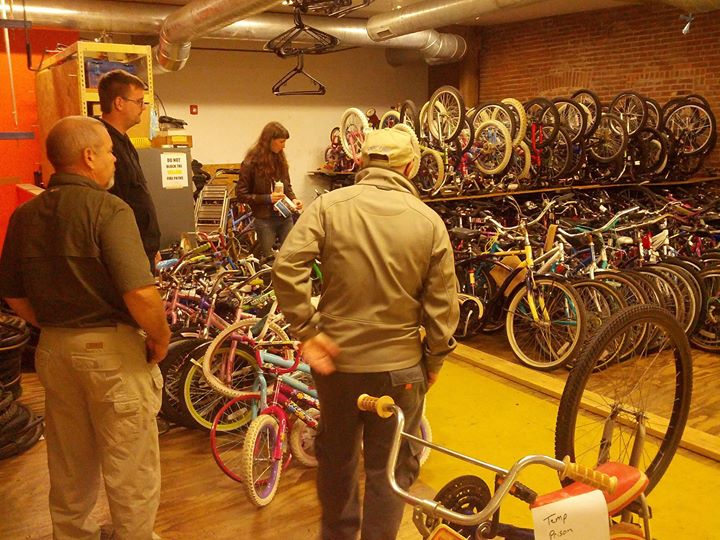 people are looking at bicycles on display in a bike store