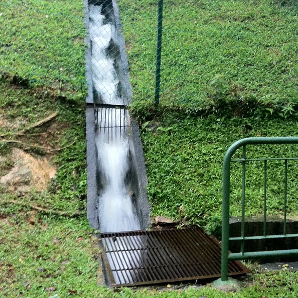 an open metal railing and water coming from it
