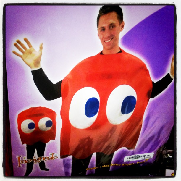 man holding a giant bag with big eyes in front of him