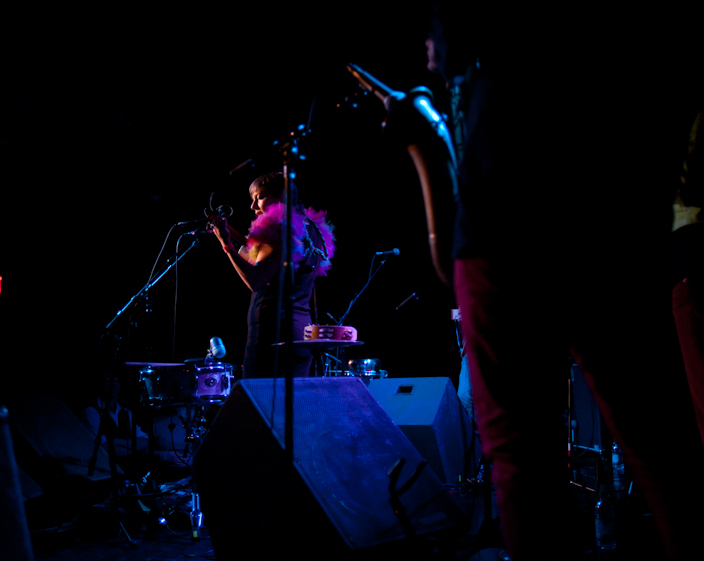 a musician playing on stage at night in a dark room