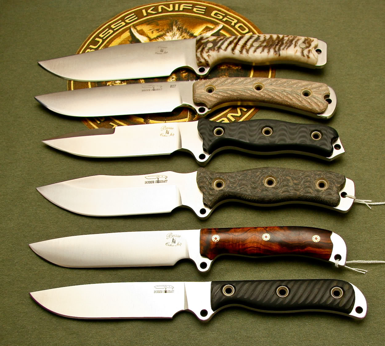 seven knives are laying in a row on a table