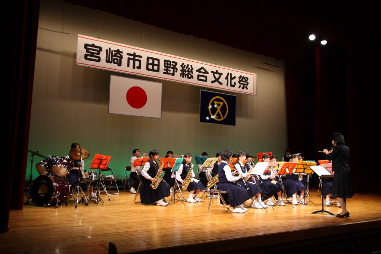 an orchestra on stage with instruments and a speaker