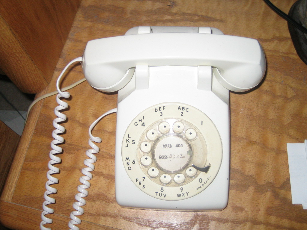 an old fashioned telephone on a wooden table