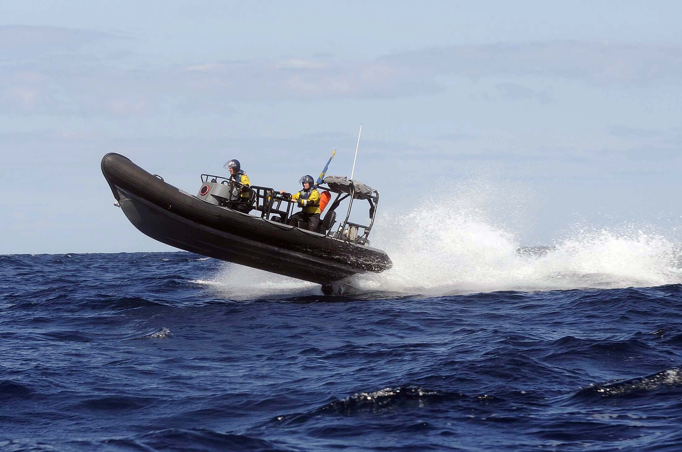 two people ride in the back of a boat