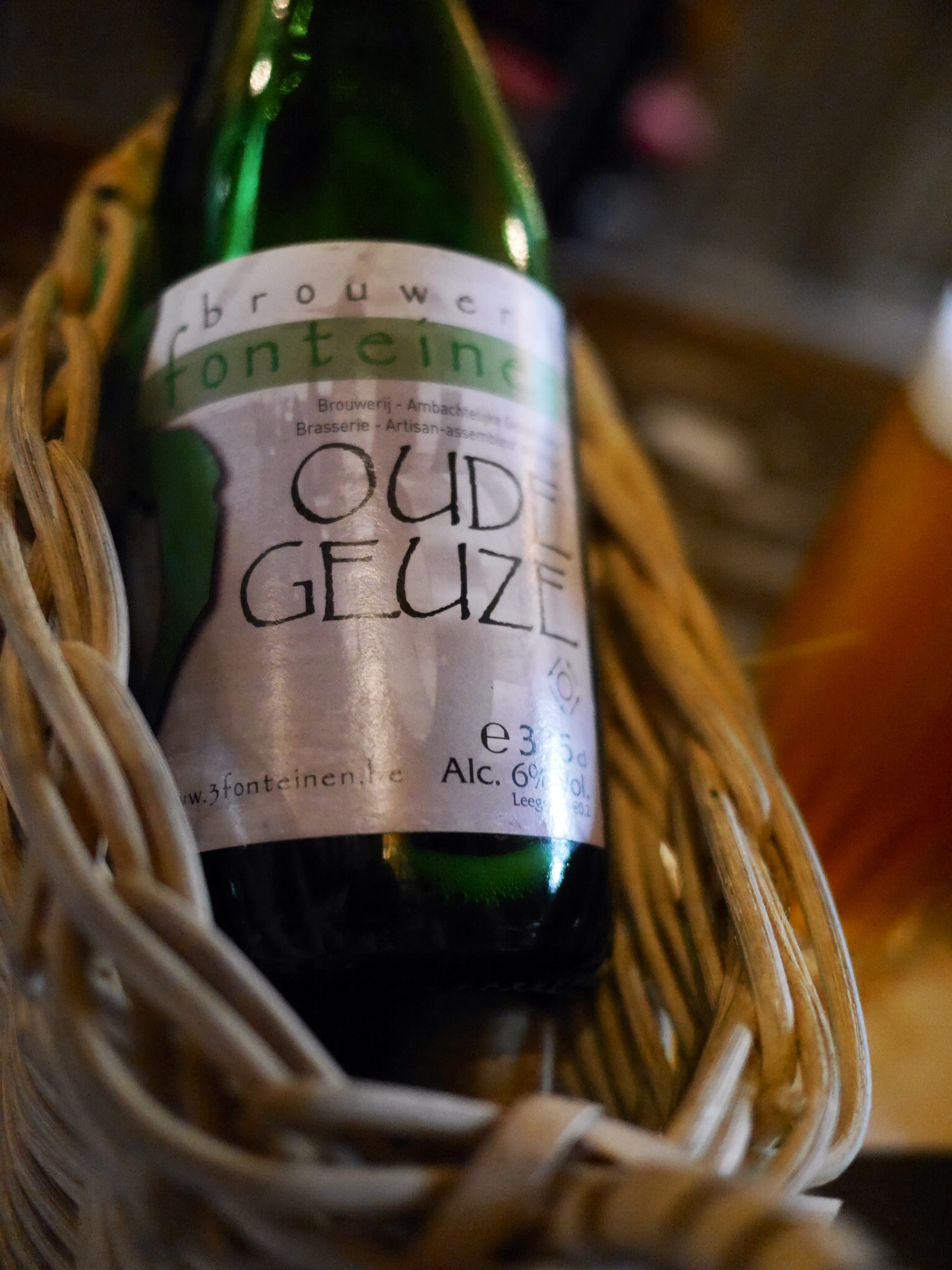 a bottle of beer that is sitting in a basket