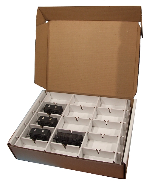 a large opened cardboard box filled with various black keys