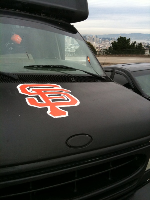 an orange and white team logo on the hood of a black truck