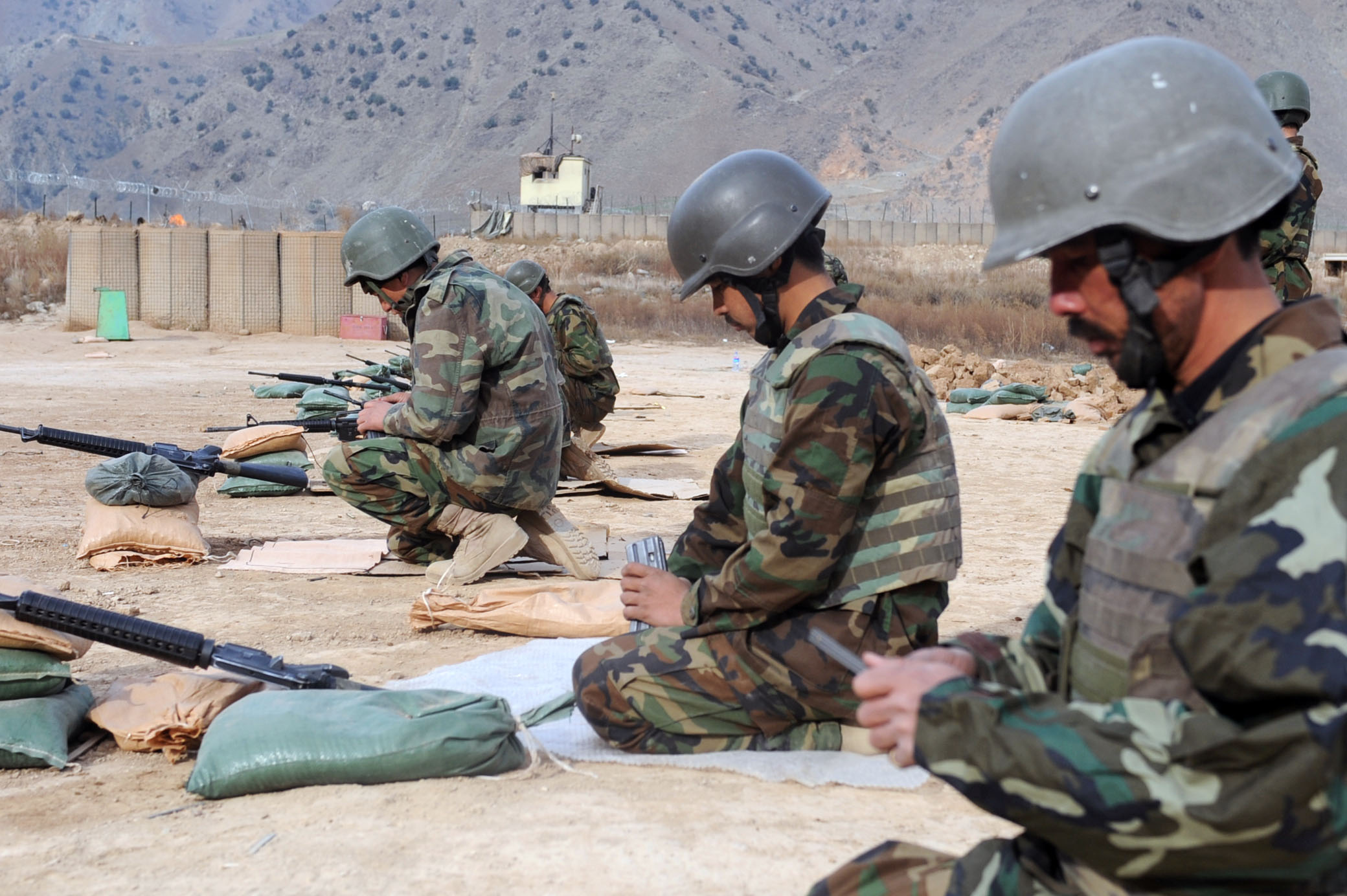 soldiers are taking position near each other in military gear