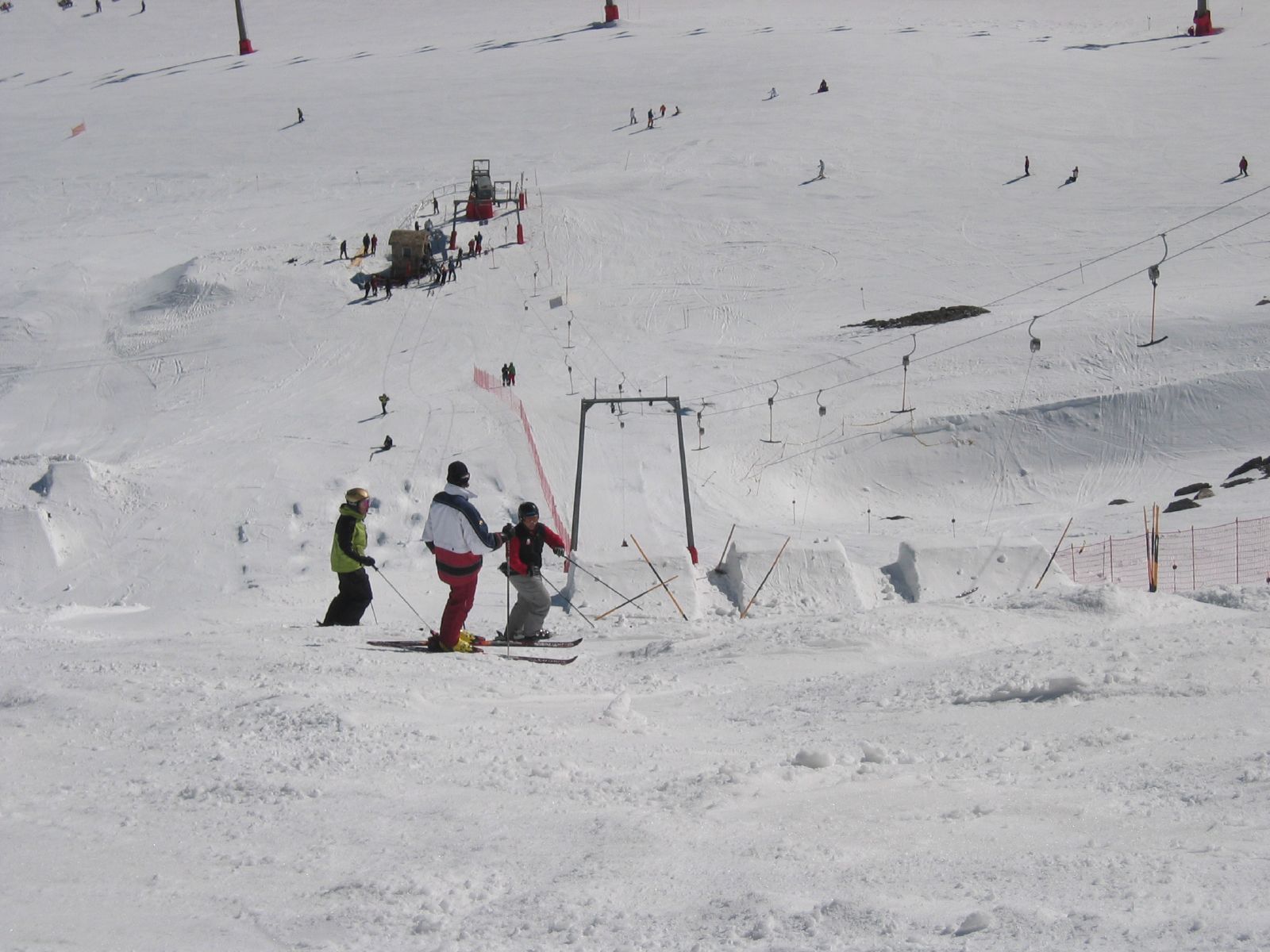 several skiers standing on snow covered ground in ski area