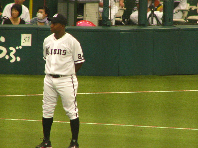 a baseball player stands on the field waiting for a pitch