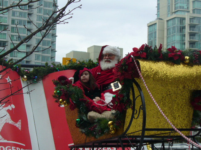 two children dressed as santa and reindeer on top of float