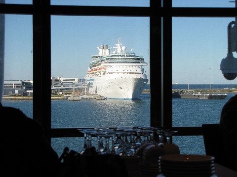 a large ship seen through windows in a restaurant
