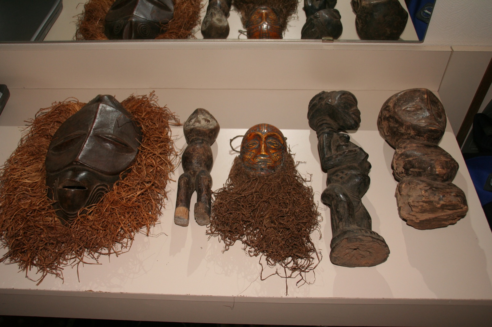 four african wooden masks and several other assorted sculptures