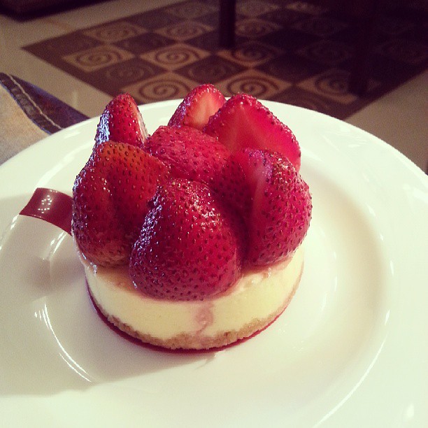 cheesecake with strawberries on a white plate