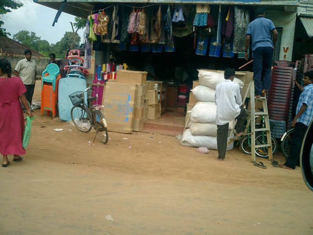 people buying merchandise at a clothing shop in an urban area