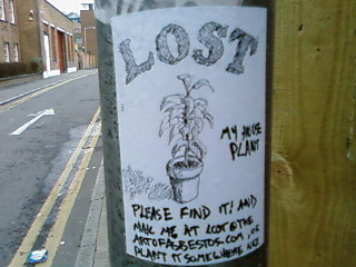 a lost plant sticker on a pole