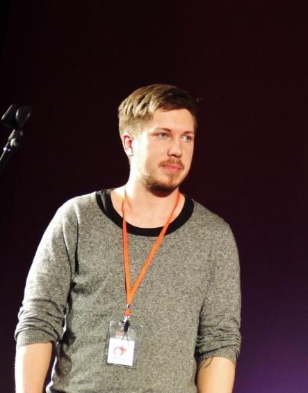 a man standing next to a microphone