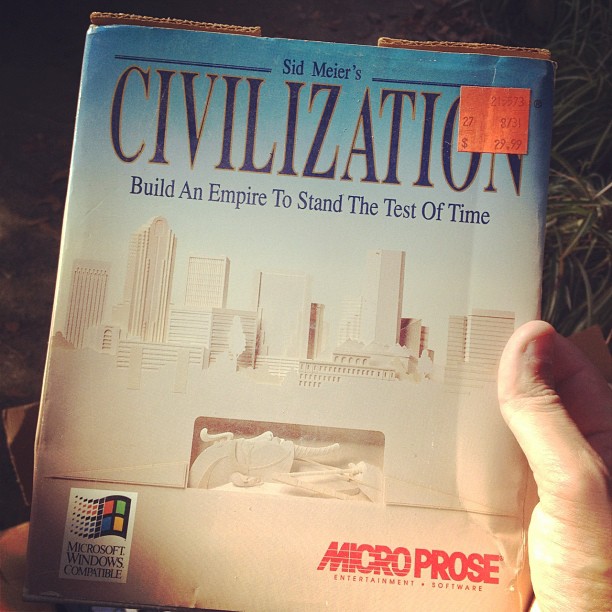 a hand holding up an architectural book about civilizing