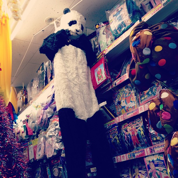 a person is wearing a panda bear costume at the store