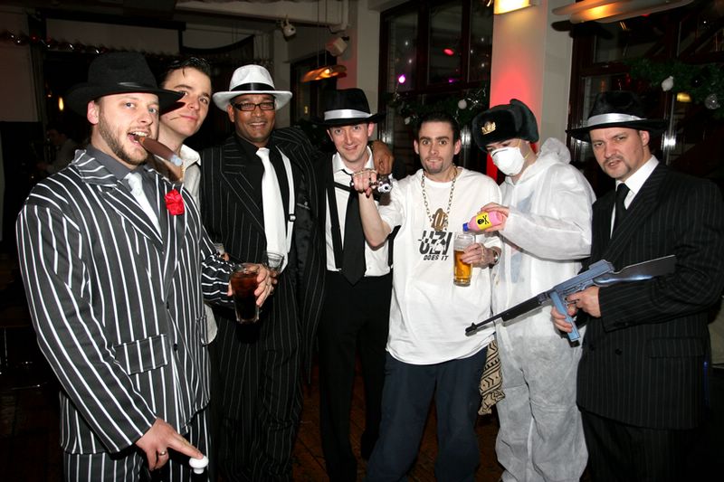 a group of men are all dressed up for a fancy party