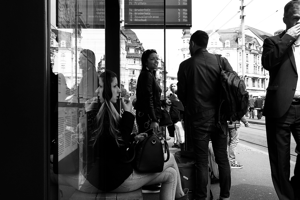 men and women walking through a crowded subway stop