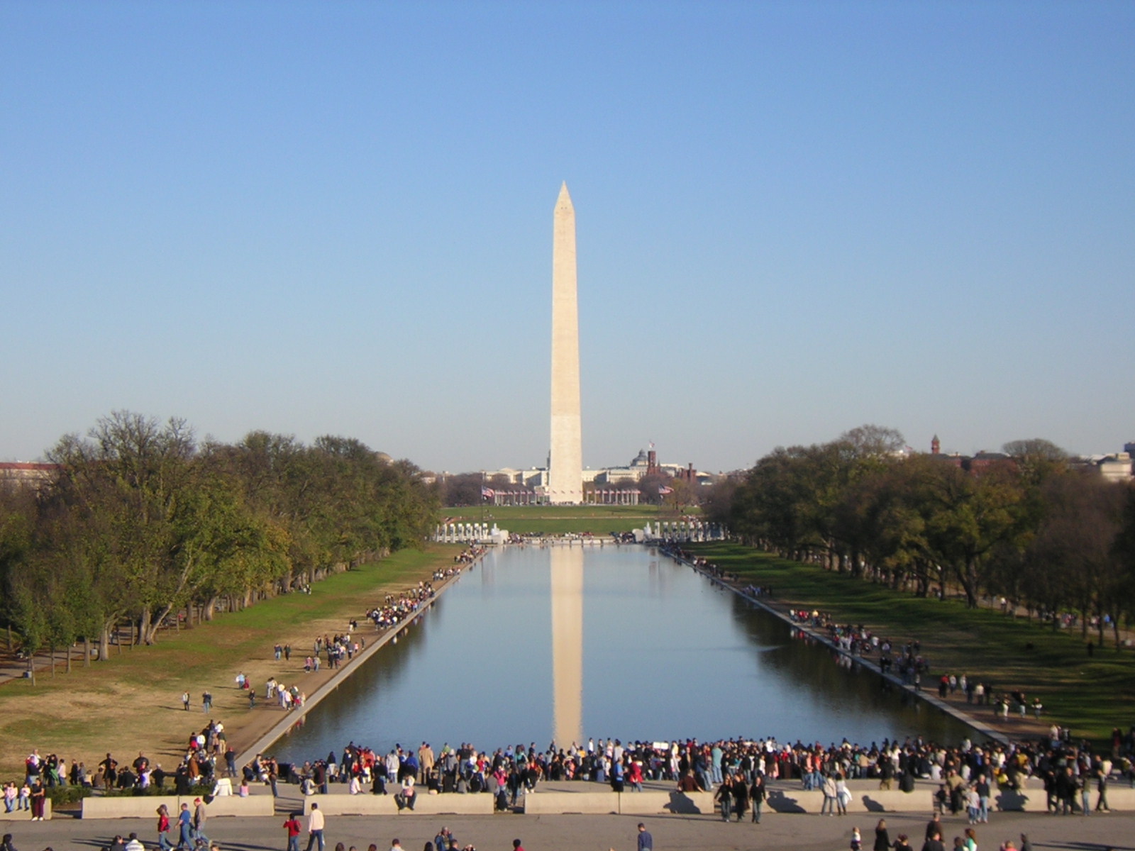 there is a large group of people standing in front of the washington monument