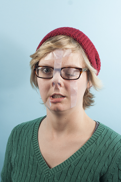 a woman has a tape over her face and nose