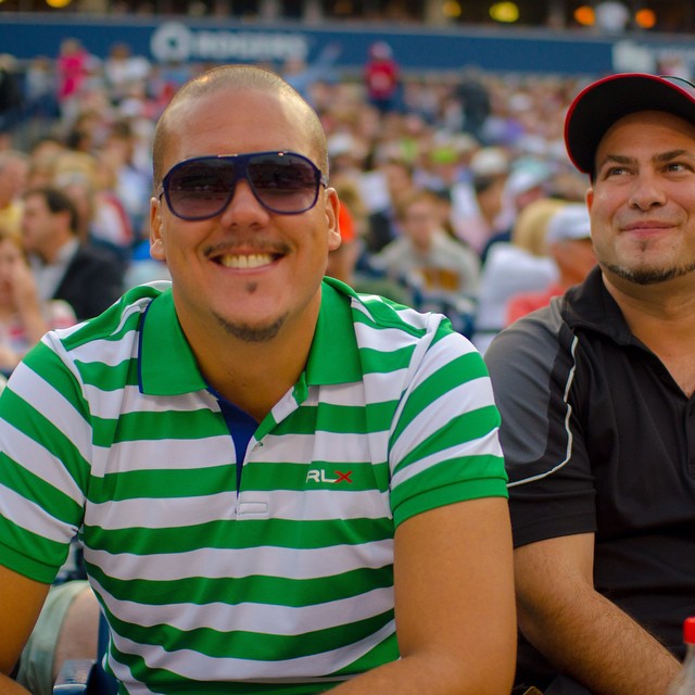 two men sit on the sidelines during a sporting event