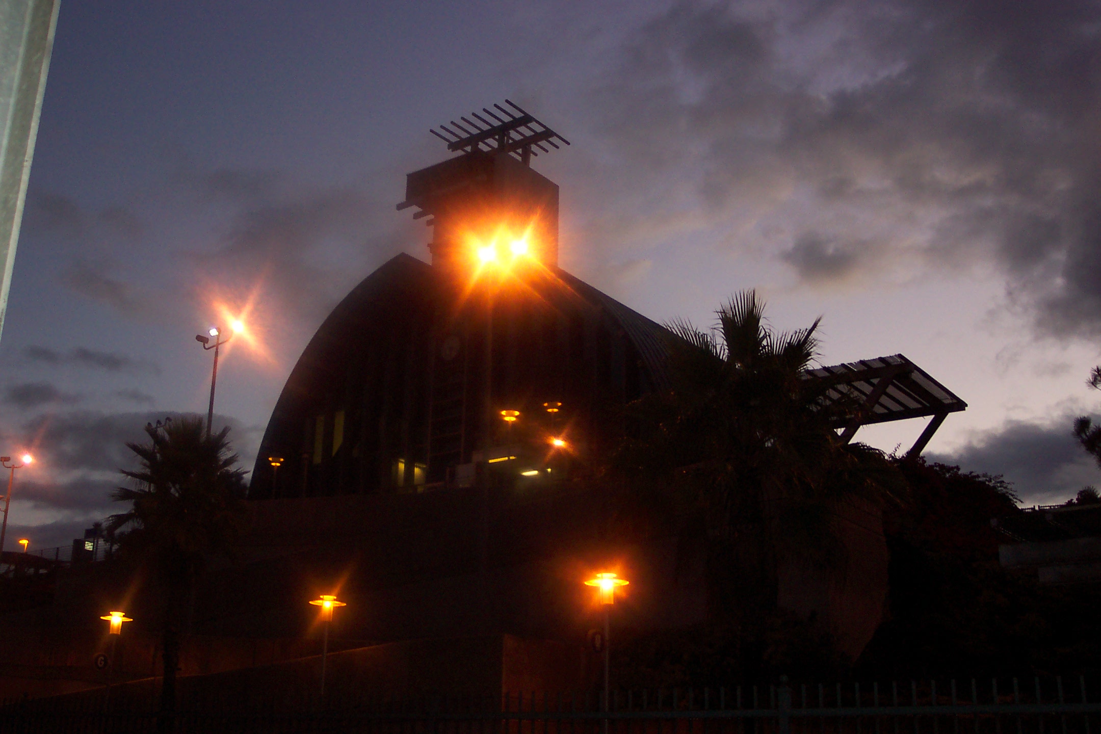 the dome of an urban building with bright lights shining in the dark