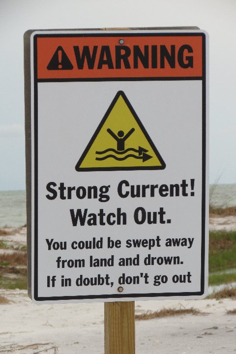 there is a sign that warns people to stay out of the water