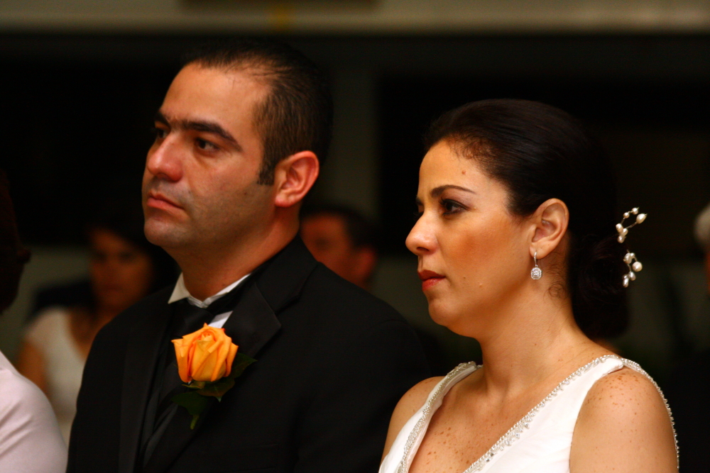 a bride and groom sitting next to each other at a wedding