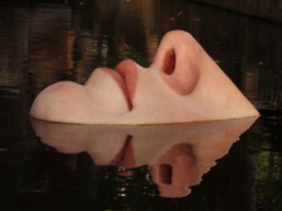 a sculpture floating on top of a body of water