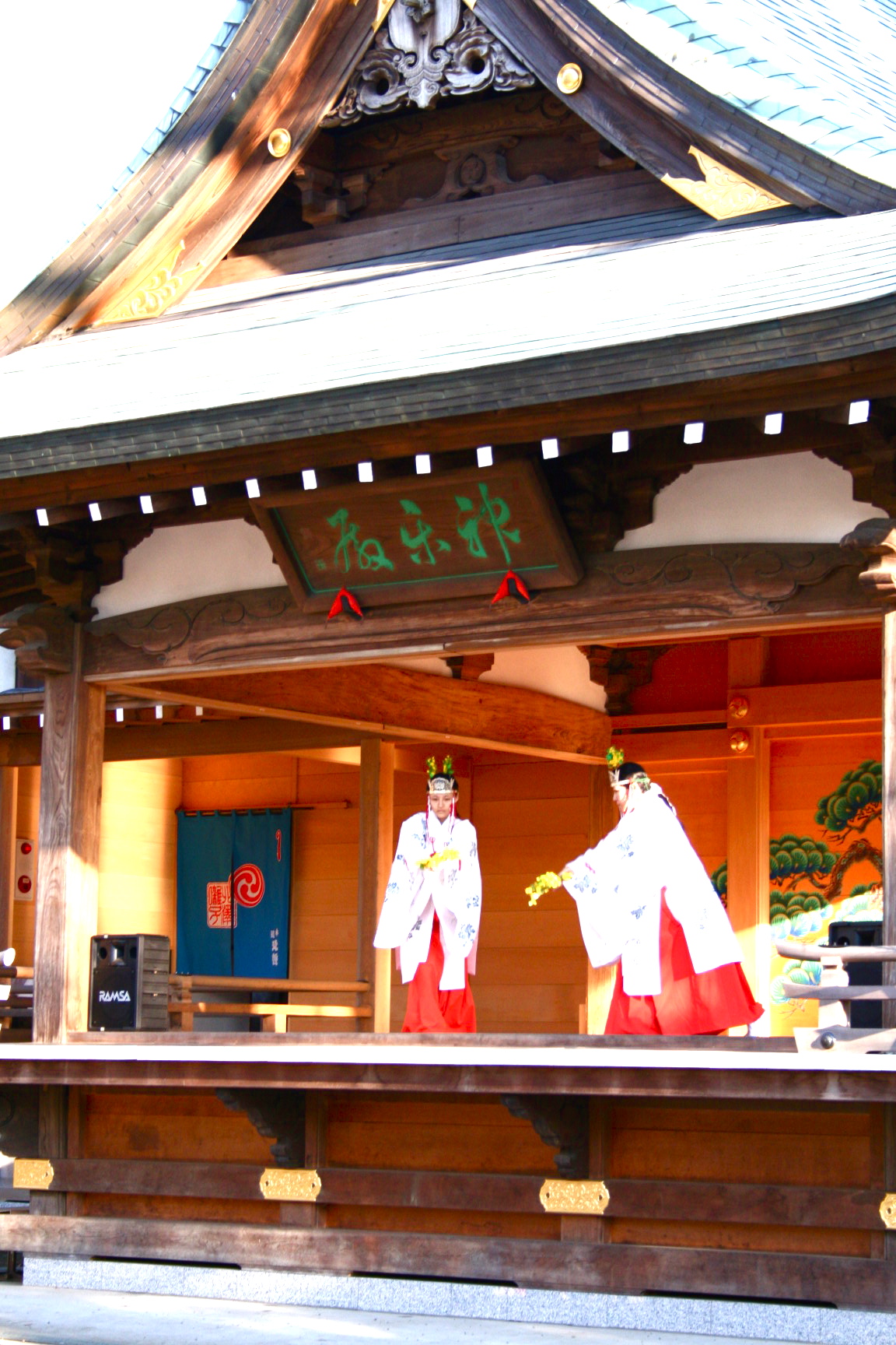 a small shrine with red and white attire and white robe on it
