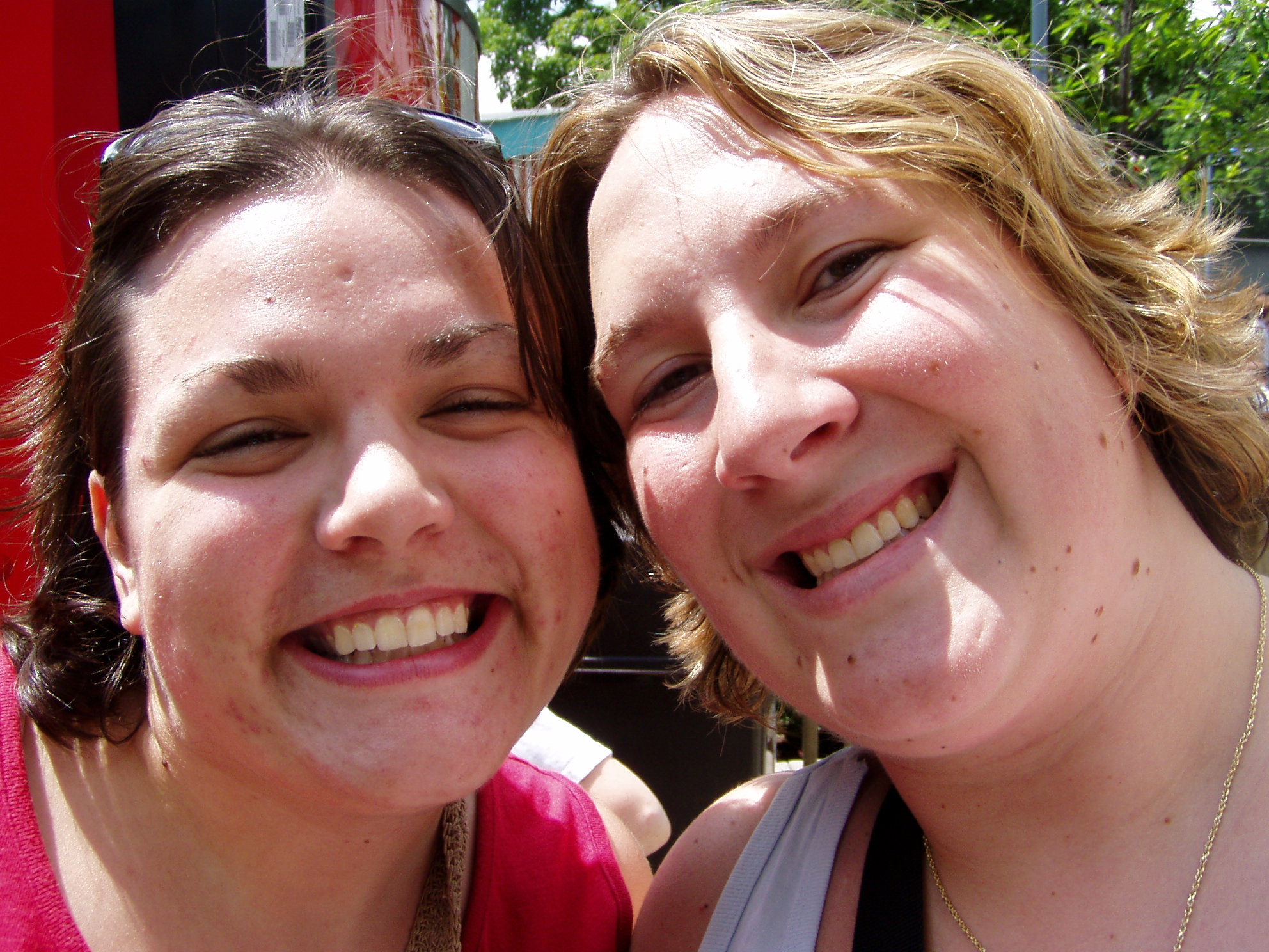 two ladies smiling, one with her eyes closed and the other slightly open