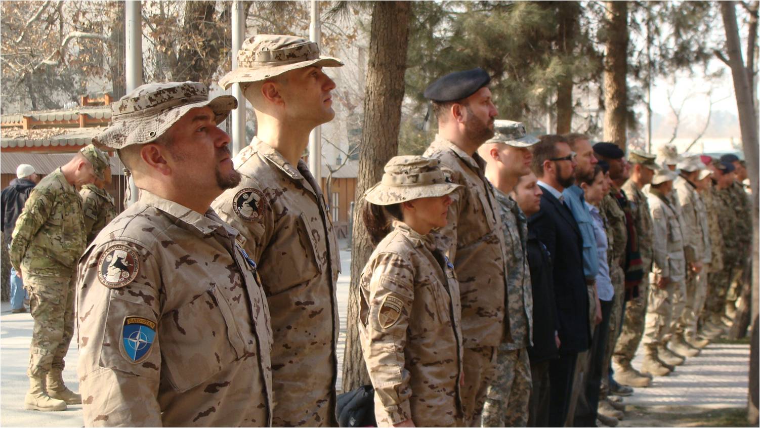 men and women are gathered in uniforms at a military ceremony