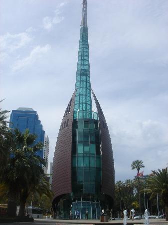 a tall building with a spire sitting above a fountain