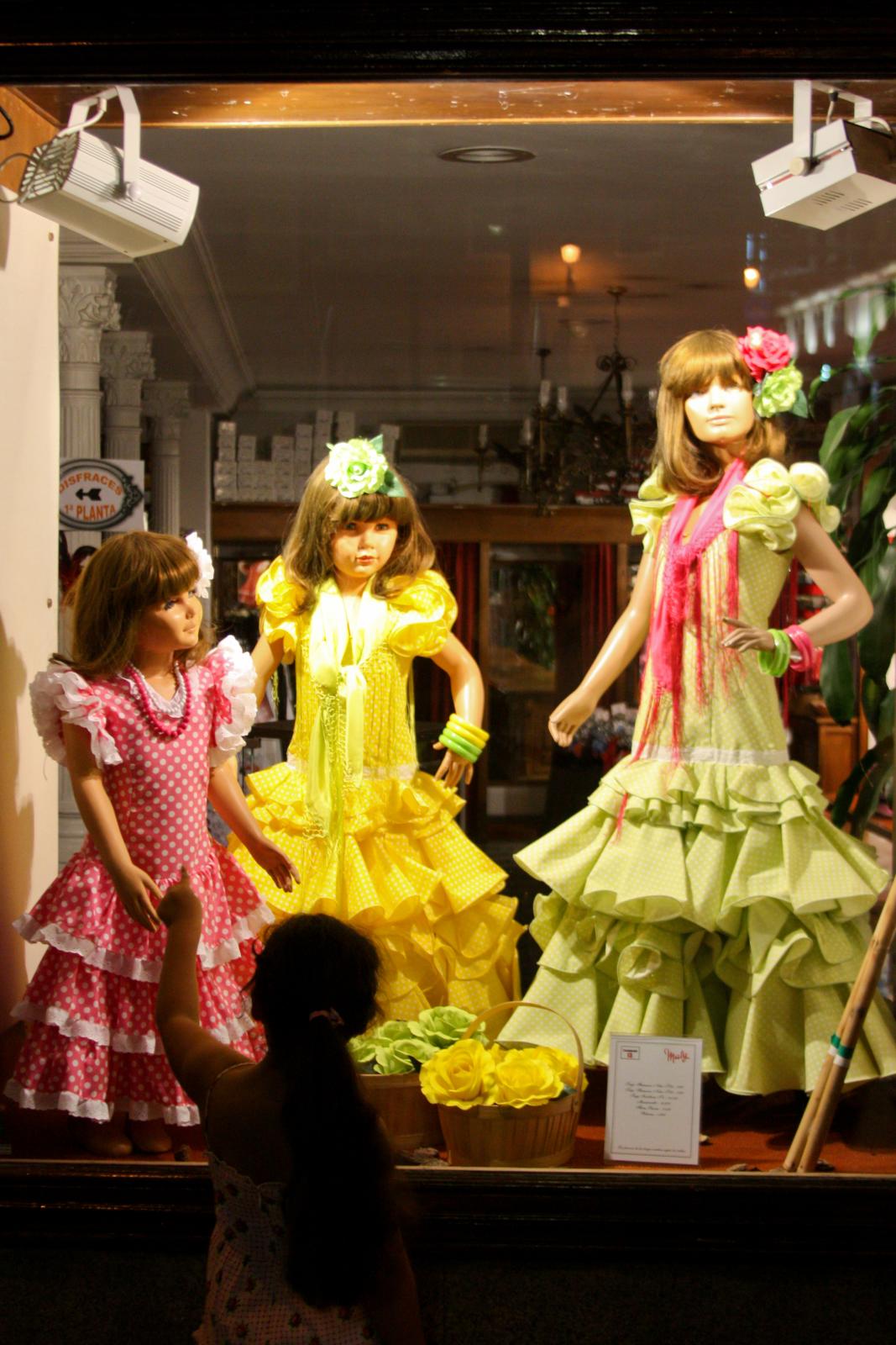 four dolls standing up inside of a display case
