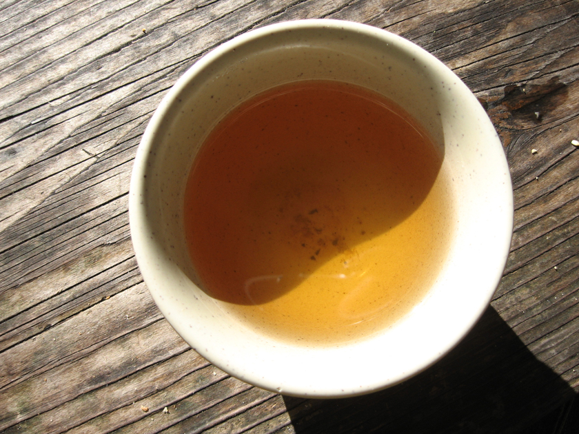 a large white bowl filled with liquid sitting on top of a wooden floor