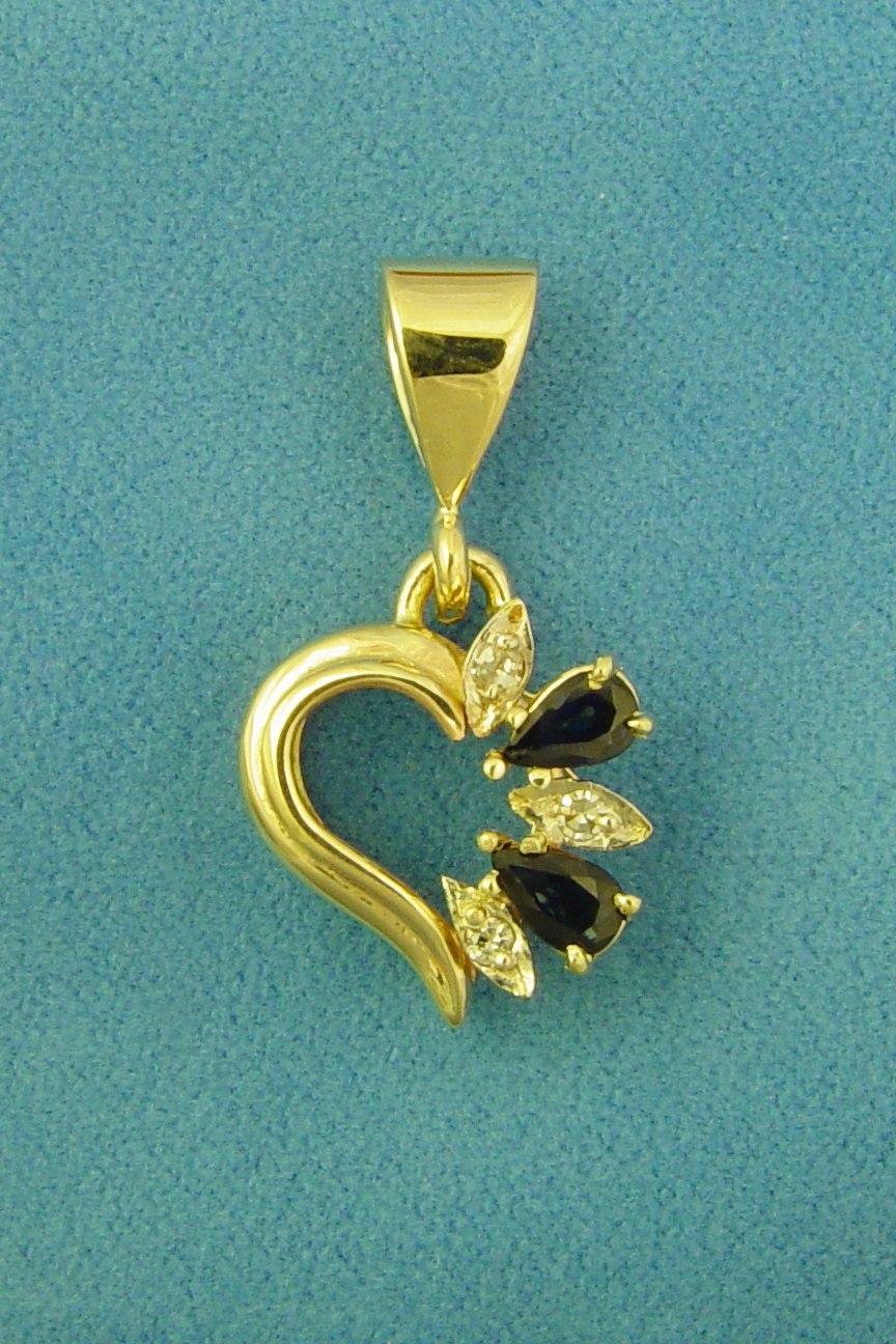 the gold pendant has a black heart in it