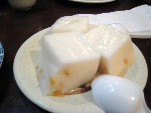 a white plate topped with cheese covered in cream