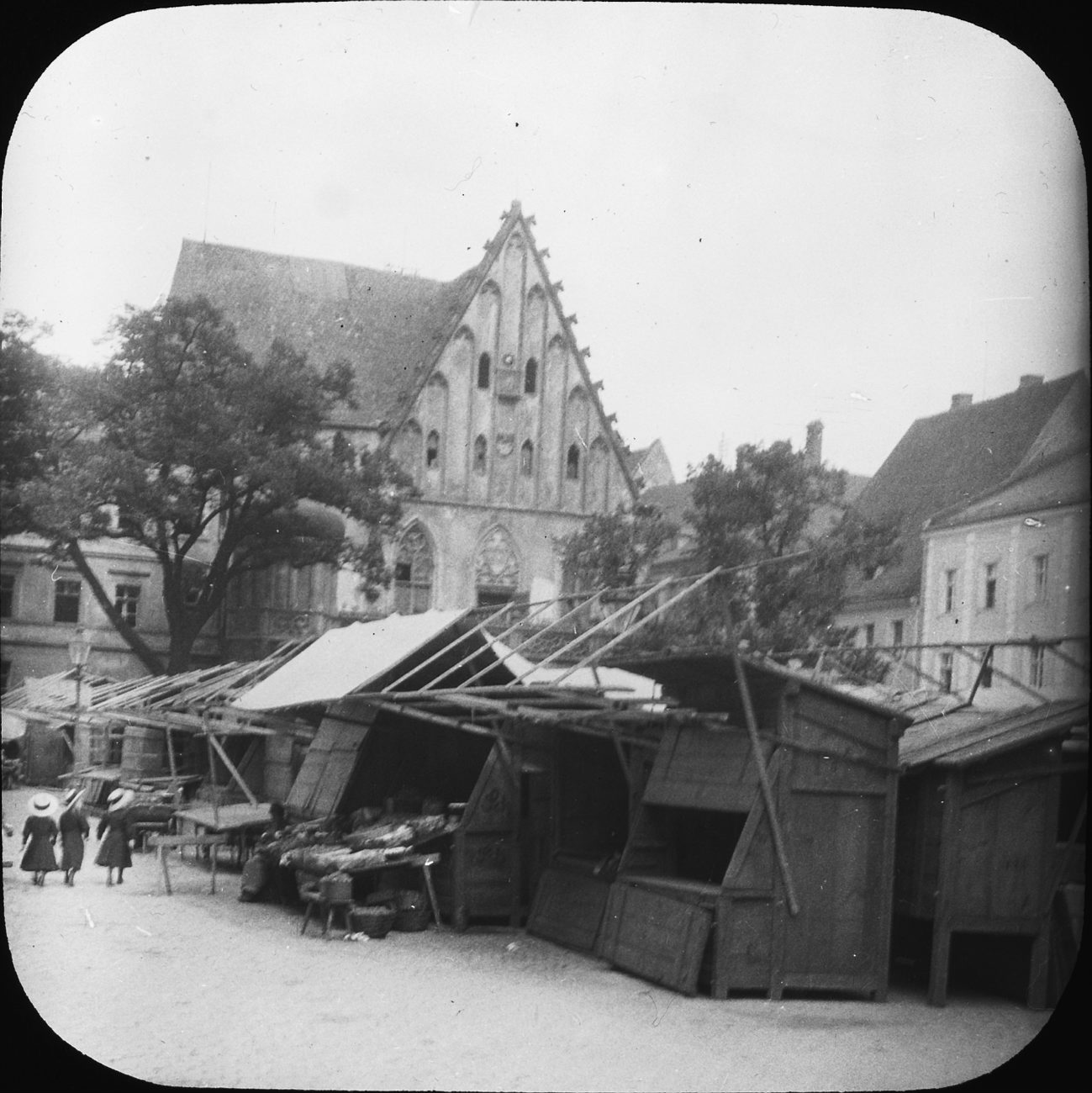 an old black and white po of people near a house