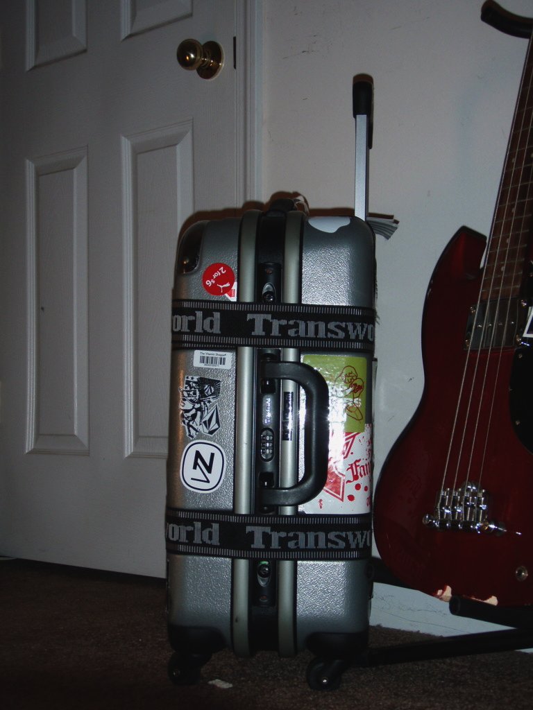 a suitcase and a guitar are placed next to each other