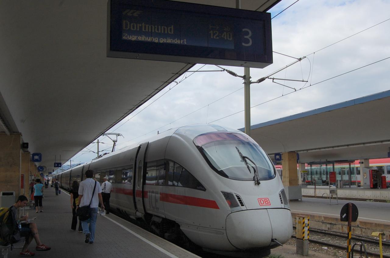 people walking on the platform by a train