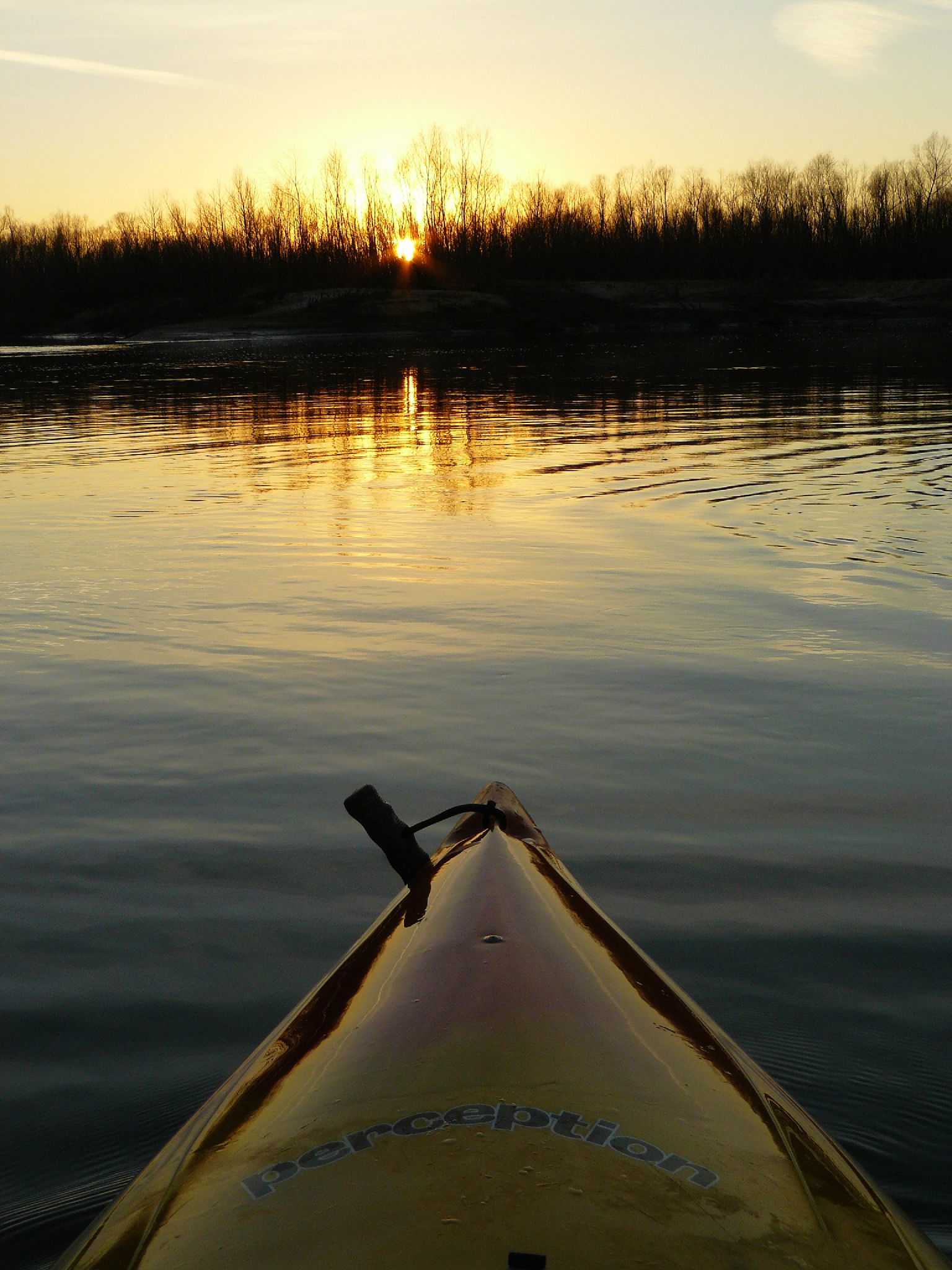 a canoe is going down the river at sunset