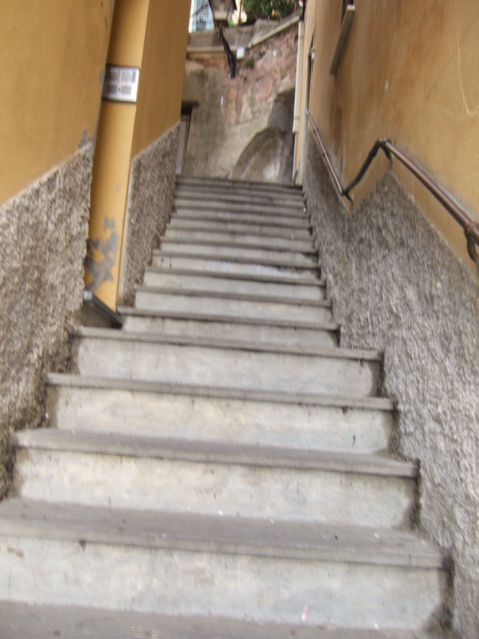 there is a set of cement stairs down that stone