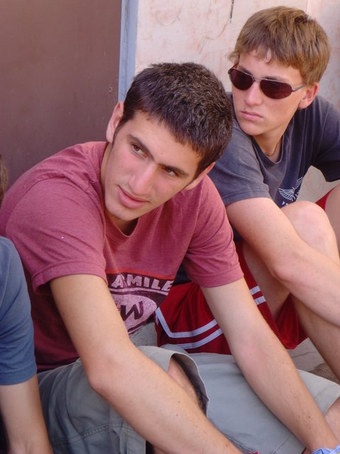 two boys in sunglasses are looking at the camera