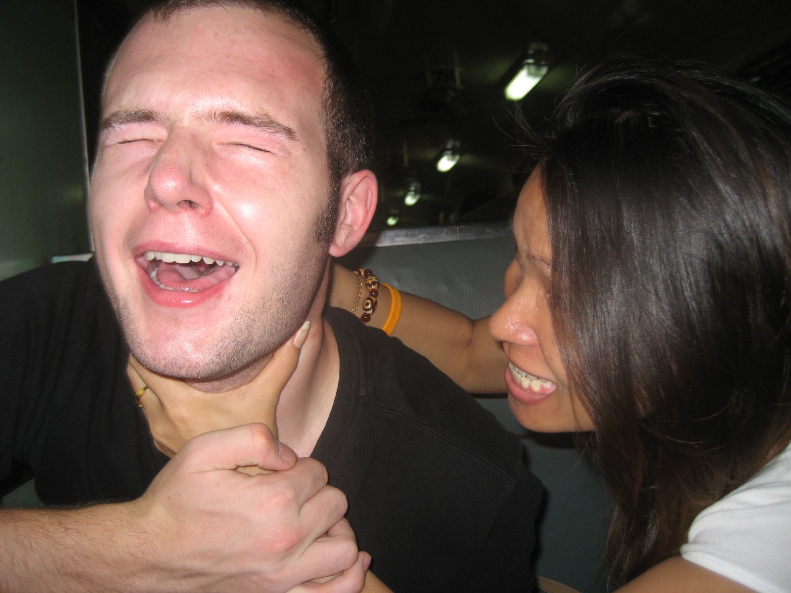 a smiling man and woman who have just took off their shirt