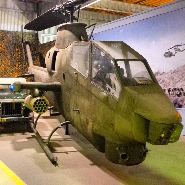 the front of a military green helicopter is on display