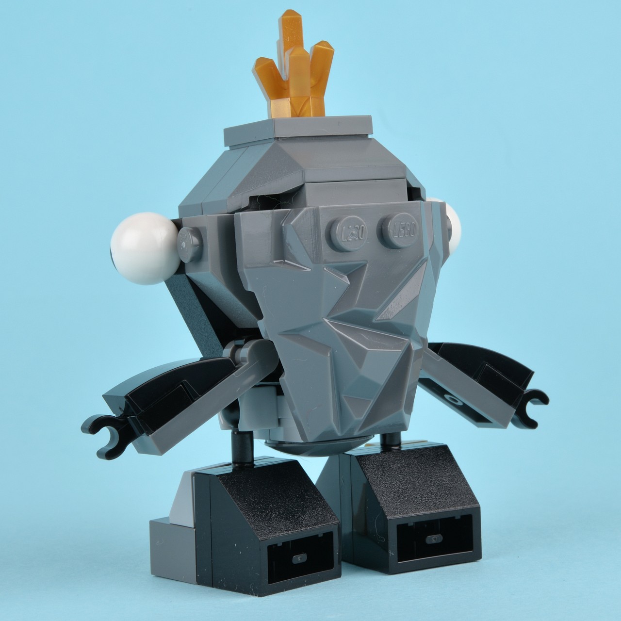 a very small lego toy robot with black legs