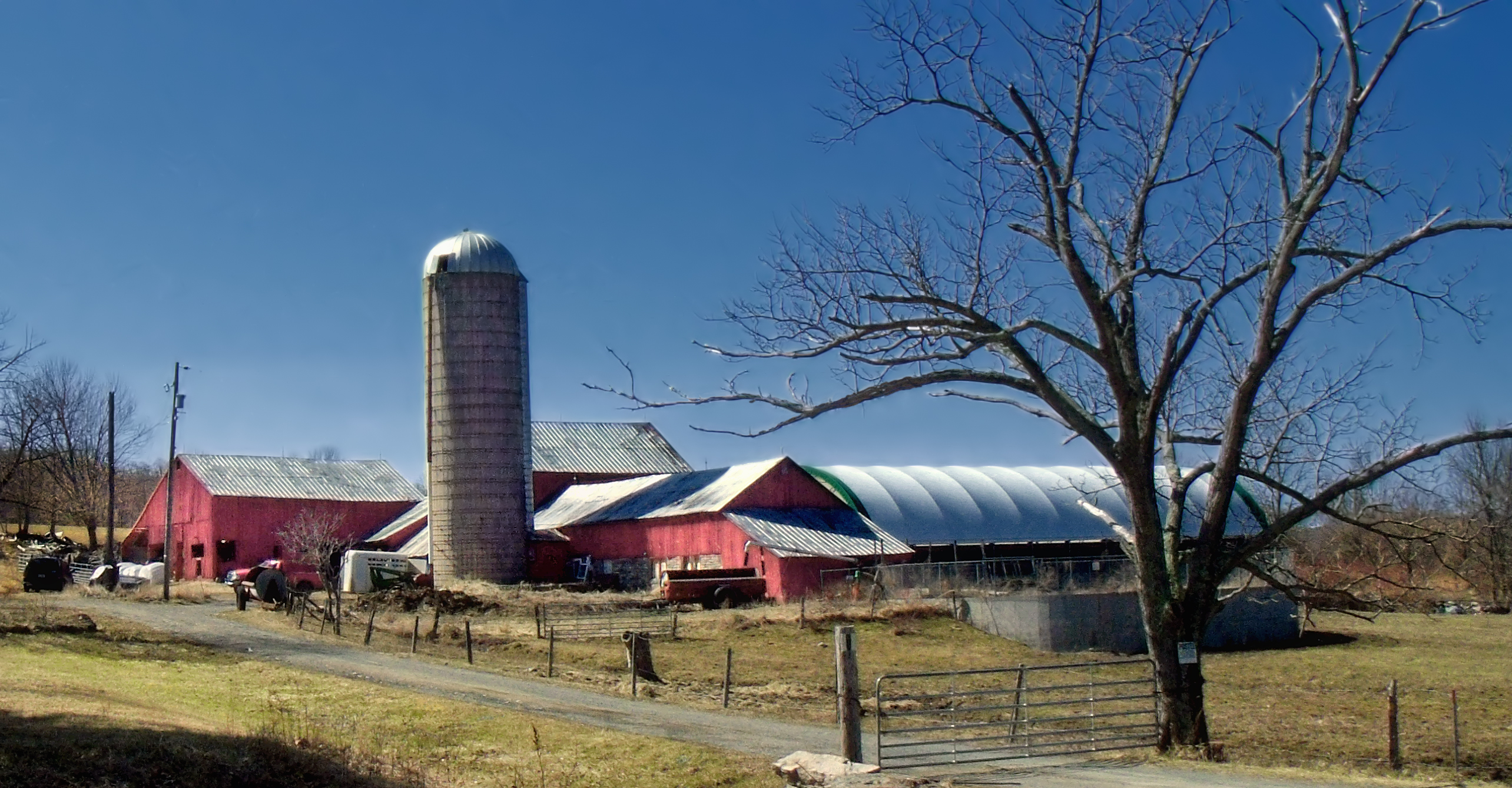 there is a barn and silo in the yard